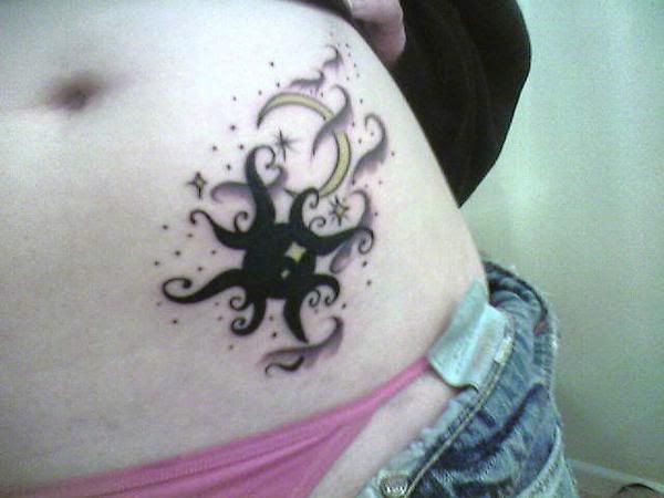 Nautical star and flowers tattoo on stomach. Stars stomach tattoo.