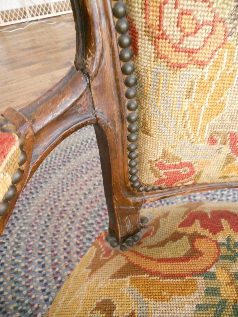 Antique French Needlepoint Arm Chair with Elegant Carved Wooden Frame